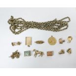 Quantity of gold charms to include British passport, pram, boot, cased banknotes and others and a