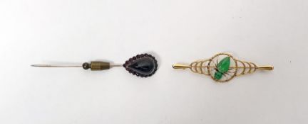 Gold-coloured metal and jade brooch having central spider with jade body and a garnet set stickpin