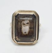 9ct gold and smoky quartz dress ring, the rectangular cut stone in rubover mount