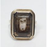 9ct gold and smoky quartz dress ring, the rectangular cut stone in rubover mount