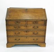 George III oak and mahogany crossbanded bureau of two short drawers over three long drawers to