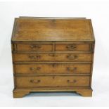 George III oak and mahogany crossbanded bureau of two short drawers over three long drawers to