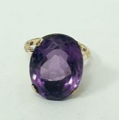 9ct gold ring set with large oval amethyst-coloured stone, claw set