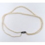 Double string of graduated cultured pearls on silver and marcasite set clasp in Martin & Co,