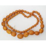 Long string of graduated yellow oval amber beads, weight 161g, 102cm long approx, largest bead 3cm