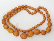 Long string of graduated yellow oval amber beads, weight 161g, 102cm long approx, largest bead 3cm