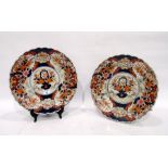 Pair of Imari chargers, each painted with a central cartouche and jardiniere of flowers, the borders