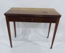 A 19th century mahogany tea table, the fold-over top above single drawer, on reeded tapering