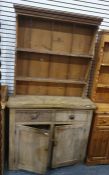 Pine dresser with two plate shelves under moulded cornice over two short drawers and a two door