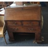 19th century oak bureau of two short over one long drawer, the recessed base raised upon bracket