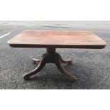 A 19th century mahogany table, the rectangular top with rounded corners on single pedestal to four