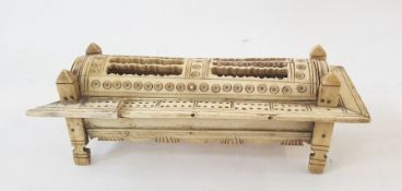 Carved prisoner of war dominoes box containing numerous miniature dominoes, sarcophagus shaped