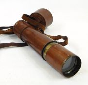 A brass leather covered three draw telescope inscribed "Reconditioned for John Barker and Co Ltd,