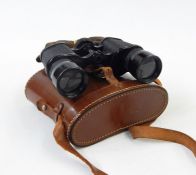 Four pairs of various vintage binoculars in leather cases, all in woven basket  Condition