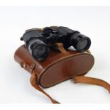 Four pairs of various vintage binoculars in leather cases, all in woven basket  Condition