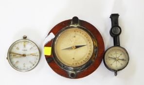 Small brass compass on wooden plaque, a continental metal and glass compass and a German black metal