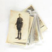 Large collection of WWI photographic postcards, various regiments, caps, etc.