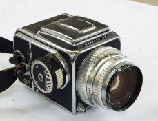 Hasselblad 500C camera with HASSELBLAD Plainar 1:28 lens, a Hasselblad Film Magazine A12 (boxed),