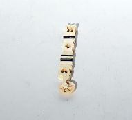 Carved bone prisoner of war pastry jigger, pierced with hearts and diamonds and banded in black,