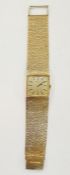 Gent's 9ct gold Longines wristwatch with gold bark-finish face and integral bark-finish cuff