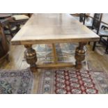 Large 17th century style carved oak draw leaf dining table, on cup and cover supports and