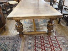 Large 17th century style carved oak draw leaf dining table, on cup and cover supports and