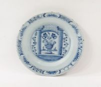 Antique Delft plate painted in underglaze blue with vase of flowers between pillars and brick