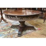 20th century Eastern hardwood circular coffee table with bead moulded edge above single turned and