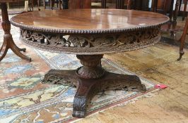 20th century Eastern hardwood circular coffee table with bead moulded edge above single turned and