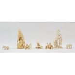 Chinese carved ivory okimono in the form of man with turtle, boy seated at his feet, 10cm high; a