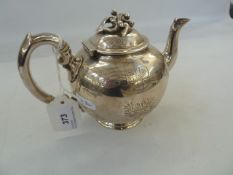 Late Victorian silver bachelor's bullet shaped teapot, the hinged cover with foliate surmount,