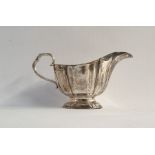 Edwardian silver sauce boat with reeded handle and raised on single oval foot, Sheffield 1904, 5.