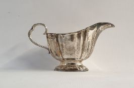 Edwardian silver sauce boat with reeded handle and raised on single oval foot, Sheffield 1904, 5.