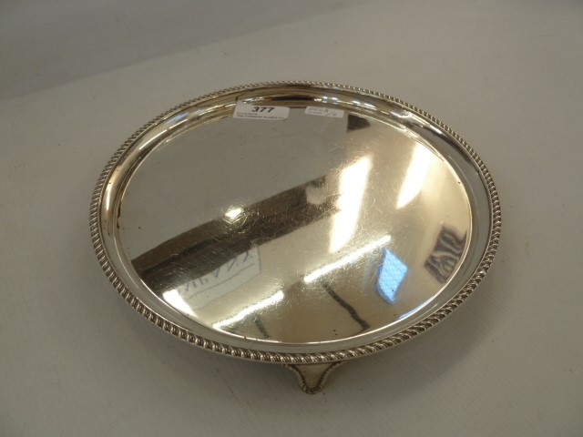 Silver circular presentation card tray with gadrooned border, raised on splayed feet, Birmingham