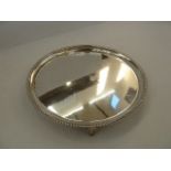 Silver circular presentation card tray with gadrooned border, raised on splayed feet, Birmingham