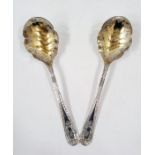 Pair of Victorian silver-gilt serving spoons, each with scalloped foliate engraved gilded bowl,