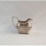 Silver cream jug with foliate borders and ribbed body, raised on ball feet, London 1813, 6oz approx