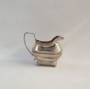 Silver cream jug with foliate borders and ribbed body, raised on ball feet, London 1813, 6oz approx