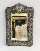 Edwardian silver toilet mirror, rectangular with shaped top, vacant cartouche, all over floral and