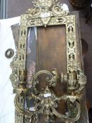 Pair of elaborate brass-framed rectangular mirrors with two-branch candle sconces (mirrors