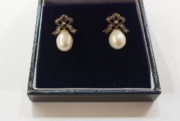 Pair of white and yellow metal, diamond and pearl drop earrings, each with diamond set bow and