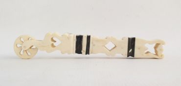 Carved bone prisoner of war pastry jigger, pierced with hearts and diamonds, banded in black, 18cm