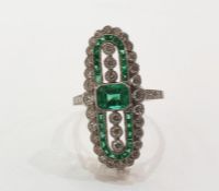 Platinum, emerald and diamond Art Deco style ring, the elongated oval set with central emerald