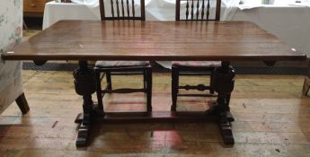 20th century oak refectory-type dining table, the rectangular top on turned and carved supports,