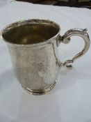 Silver presentation mug with scroll handle on circular foot, initialled and dated 10cm h, London