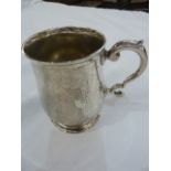 Silver presentation mug with scroll handle on circular foot, initialled and dated 10cm h, London