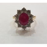 18ct yellow and white gold, ruby and diamond cluster ring, the central oval ruby 2.25ct approx,