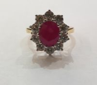 18ct yellow and white gold, ruby and diamond cluster ring, the central oval ruby 2.25ct approx,