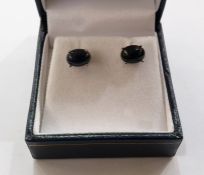 Pair of white metal Ethiopian black opal stud earrings, each set with oval cabochon stone