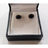 Pair of white metal Ethiopian black opal stud earrings, each set with oval cabochon stone